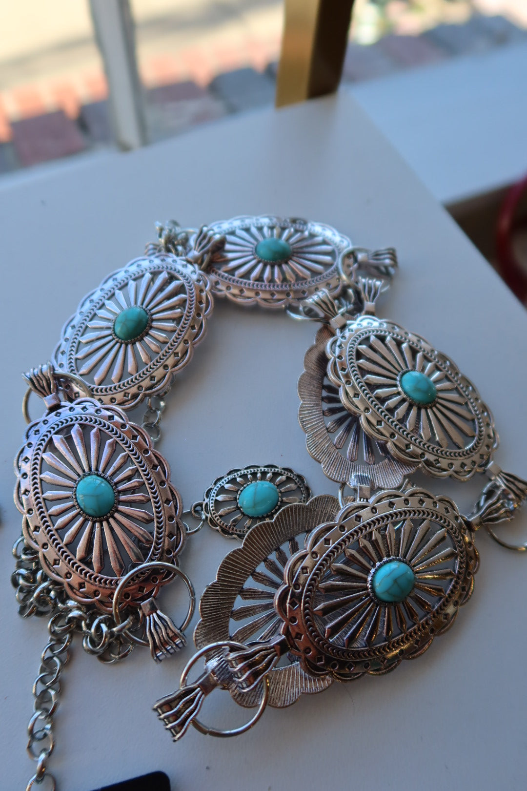 Western stone concho belt with silver accents and adjustable fit.